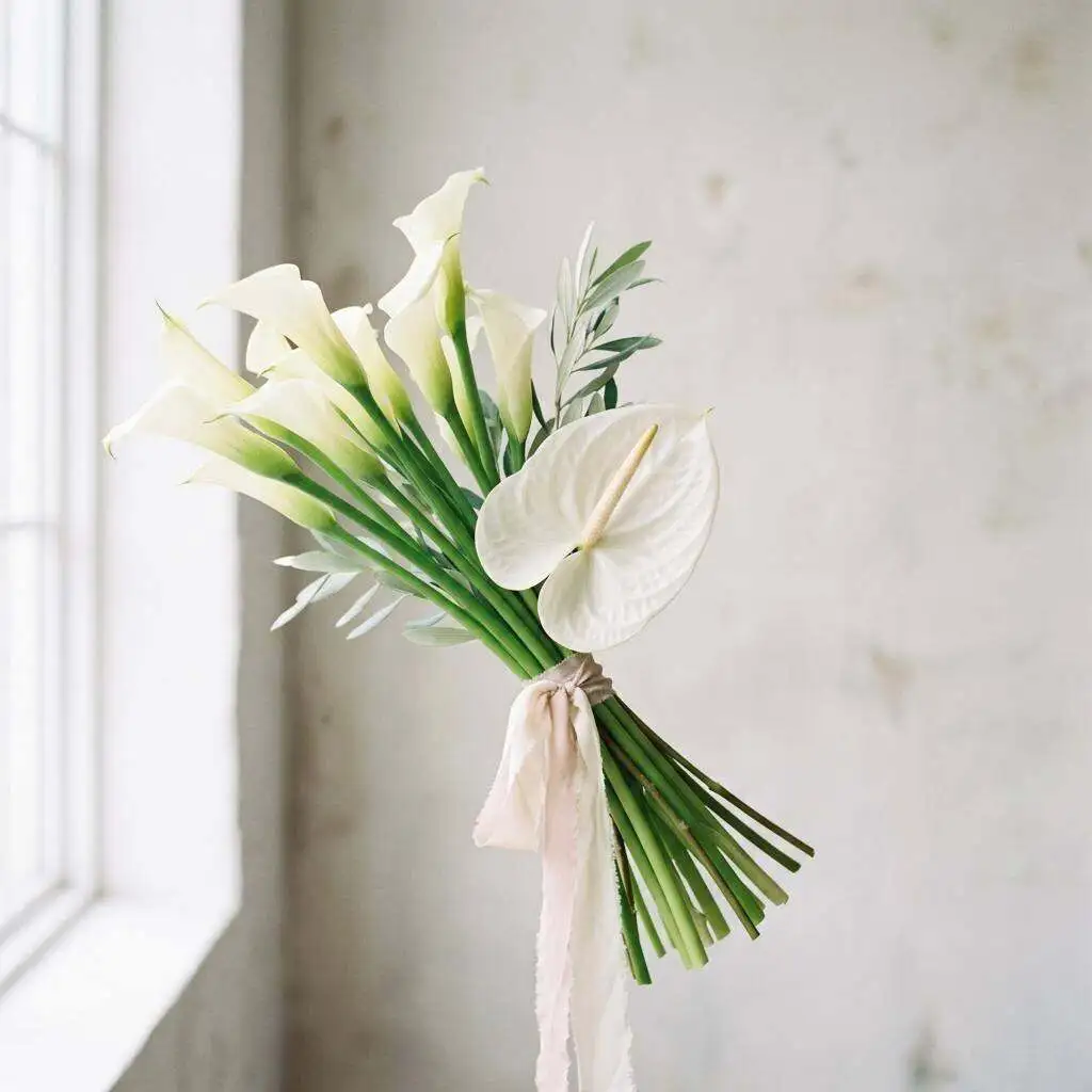 Modern minimal white arrangement on a clean ceremony table